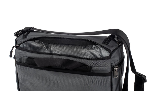 Laptop compartment open at back of Cambiata between the backpack straps and main compartment.